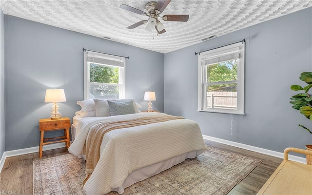 2409 Livesay Rd, Chesapeake, VA 23323 - bedroom with multiple windows, baseboards, and wood finished floors