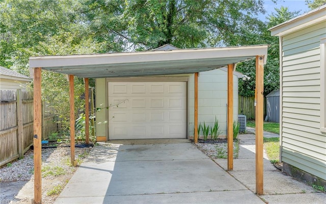 2409 Livesay Rd, Chesapeake, VA 23323 - garage with fence, driveway, a detached garage, and central AC
