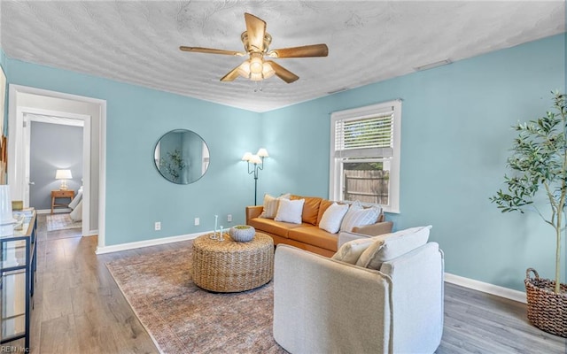 2409 Livesay Rd, Chesapeake, VA 23323 - living area featuring a ceiling fan, wood finished floors, and baseboards