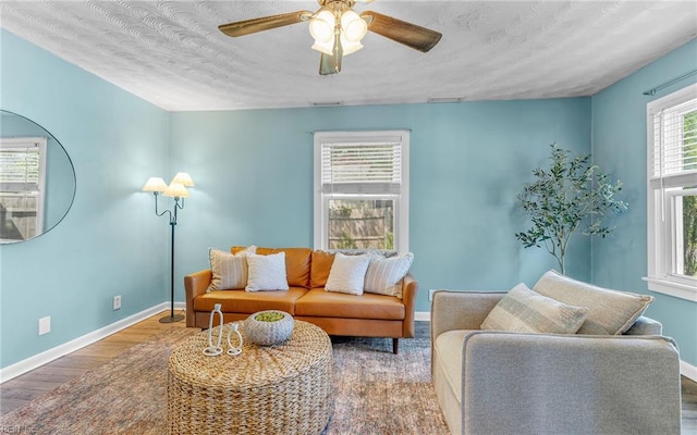 2409 Livesay Rd, Chesapeake, VA 23323 - living area with wood finished floors, ceiling fan, baseboards, and a textured ceiling