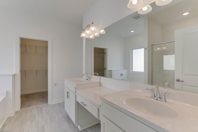 905 Cooper Ln, Chesapeake, VA 23320 - full bath with double vanity, wood finished floors, a spacious closet, a tub to relax in, and a shower