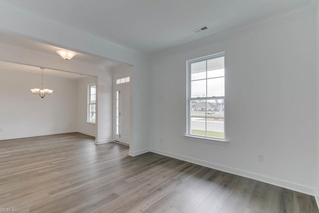 905 Cooper Ln, Chesapeake, VA 23320 - unfurnished room featuring a chandelier, healthy amount of natural light, wood finished floors, baseboards, and ornamental molding