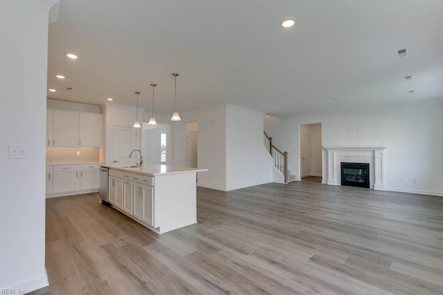 905 Cooper Ln, Chesapeake, VA 23320 - kitchen featuring a sink, dishwasher, white cabinets, open floor plan, and light countertops