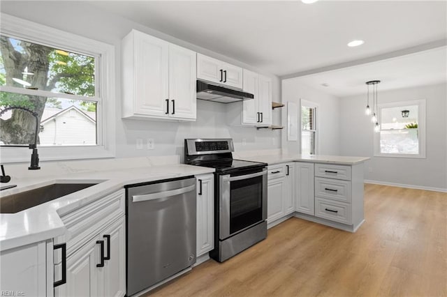 1512 Shell Rd, Chesapeake, VA 23323 - kitchen featuring stainless steel appliances, under cabinet range hood, a peninsula, white cabinets, and a sink
