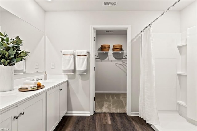 300 Mizzen Way, Elizabeth City, NC 27909 - full bathroom featuring wood finished floors, double vanity, a shower with shower curtain, and baseboards