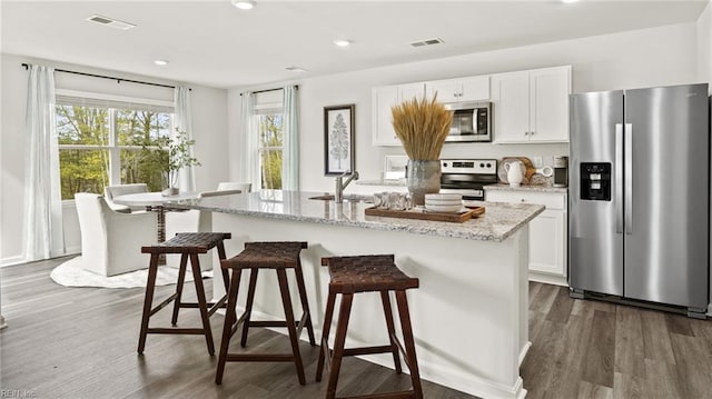 300 Mizzen Way, Elizabeth City, NC 27909 - kitchen featuring appliances with stainless steel finishes, dark wood-style floors, a center island with sink, white cabinetry, and recessed lighting