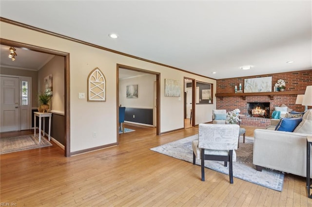 611 Windemere Rd, Newport News, VA 23602 - living area with light wood-style flooring, crown molding, a brick fireplace, baseboards, and recessed lighting