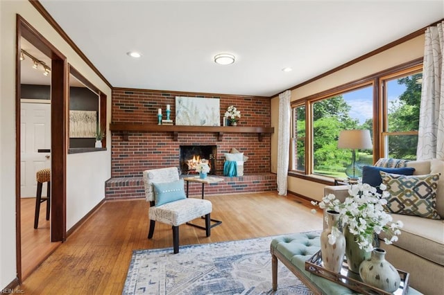 611 Windemere Rd, Newport News, VA 23602 - living area with ornamental molding, wood finished floors, baseboards, a brick fireplace, and brick wall