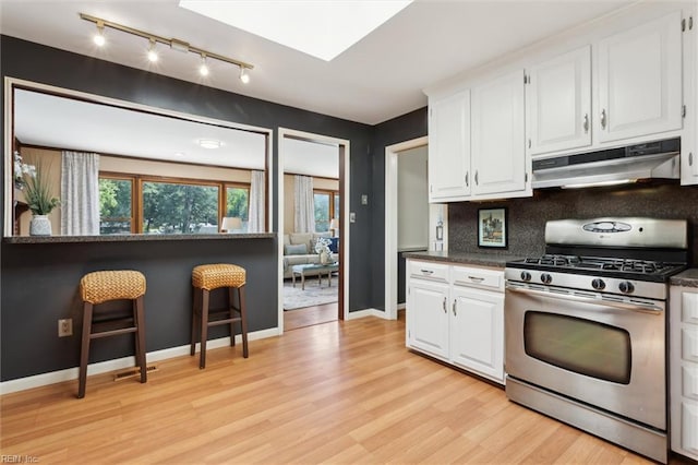 611 Windemere Rd, Newport News, VA 23602 - kitchen featuring stainless steel range with gas cooktop, under cabinet range hood, track lighting, and white cabinetry