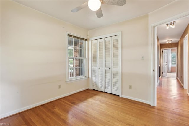 611 Windemere Rd, Newport News, VA 23602 - unfurnished bedroom with light wood-style flooring, baseboards, a closet, and a ceiling fan