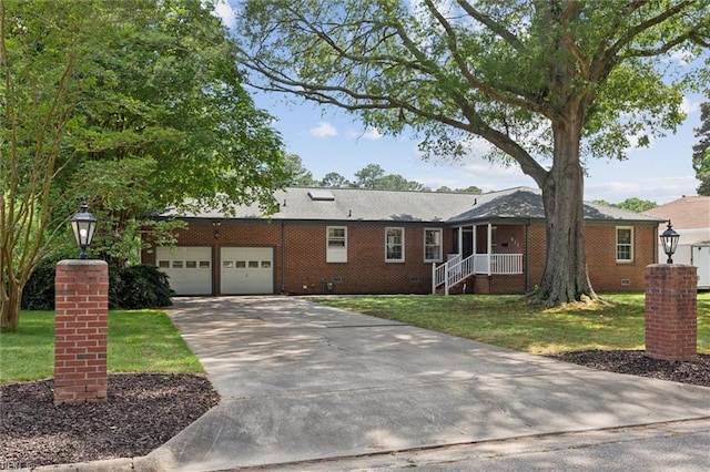 611 Windemere Rd, Newport News, VA 23602 - single story home with a front lawn, concrete driveway, a garage, and brick siding