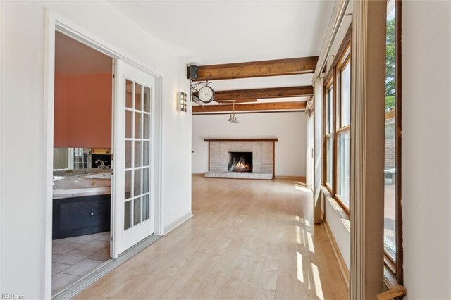 611 Windemere Rd, Newport News, VA 23602 - unfurnished living room with beam ceiling, a fireplace, and light wood-style flooring