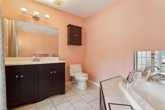 611 Windemere Rd, Newport News, VA 23602 - bathroom featuring toilet, tile patterned flooring, vanity, baseboards, and a bathtub