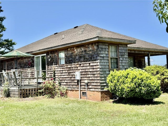 512 S End Rd, Knotts Island, NC 27950 - view of side of property featuring a yard, a wooden deck, and a shingled roof