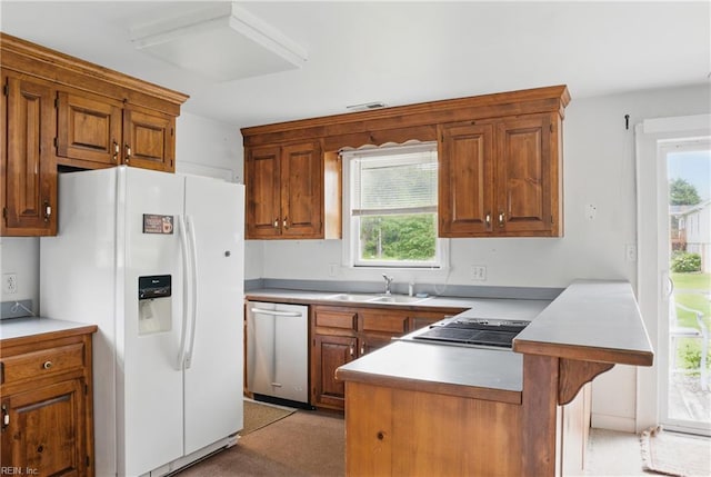 512 S End Rd, Knotts Island, NC 27950 - kitchen with white fridge with ice dispenser, a sink, stainless steel dishwasher, a peninsula, and stovetop