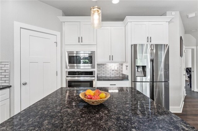 219 Dunway Ln, Chesapeake, VA 23323 - kitchen featuring appliances with stainless steel finishes, decorative backsplash, white cabinets, hanging light fixtures, and dark wood finished floors