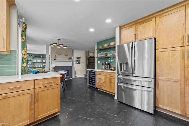 kitchen featuring stainless steel fridge, beverage cooler, a tile fireplace, open shelves, and light countertops