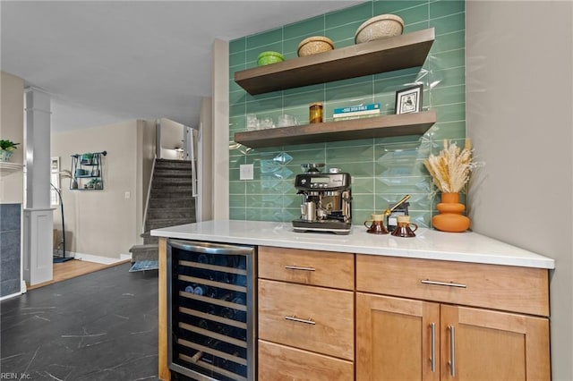 indoor dry bar with beverage cooler, stairs, dark wood-style floors, and decorative backsplash