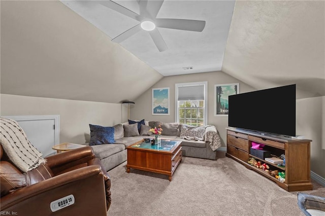 carpeted living area with vaulted ceiling, ceiling fan, and baseboards