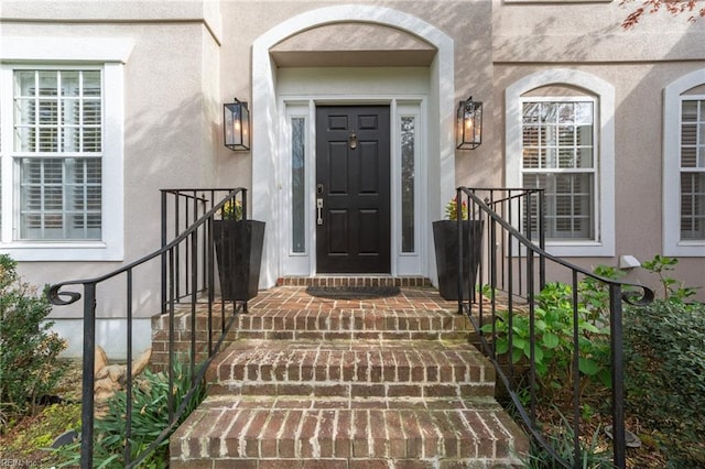 property entrance with stucco siding