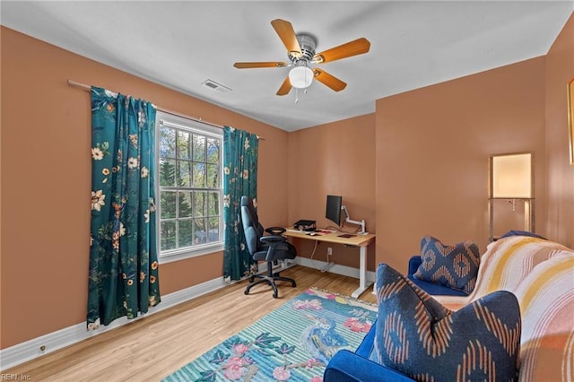 home office with baseboards, wood finished floors, and ceiling fan