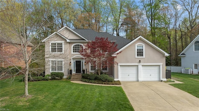 view of front of house featuring stucco siding, concrete driveway, a front yard, and central air condition unit