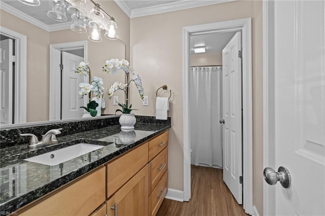 full bathroom with wood finished floors, crown molding, vanity, and baseboards
