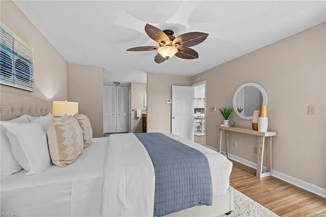 bedroom with wood finished floors, baseboards, and a ceiling fan