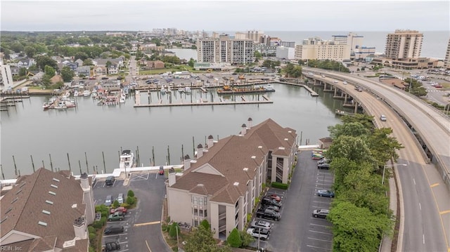 view of urban area featuring a nearby body of water, a highway, and numerous boat docks