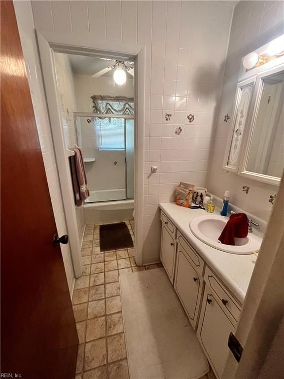3328 Northgate Dr, Virginia Beach, VA 23452 - bathroom with a stall shower, vanity, and tile walls