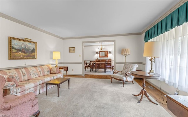 136 Crescent Dr, Franklin, VA 23851 - carpeted living room with ornamental molding, baseboards, and a chandelier