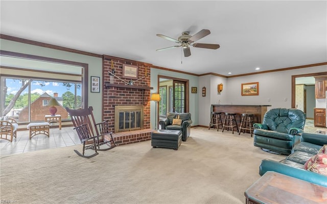 136 Crescent Dr, Franklin, VA 23851 - carpeted living room featuring a bar, ornamental molding, a ceiling fan, baseboards, and a brick fireplace