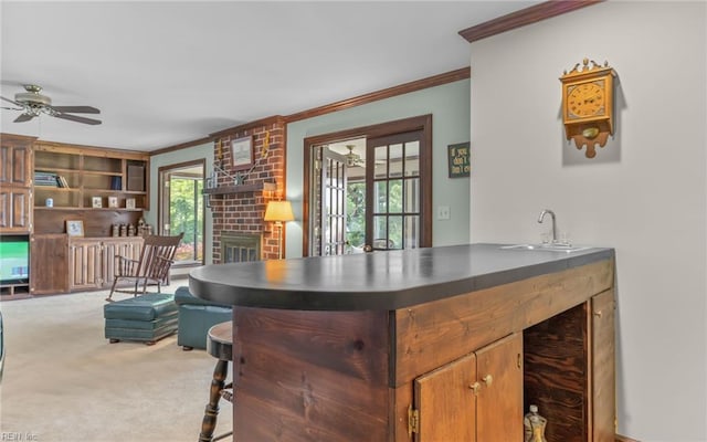 136 Crescent Dr, Franklin, VA 23851 - bar featuring ornamental molding, carpet flooring, a sink, ceiling fan, and a brick fireplace
