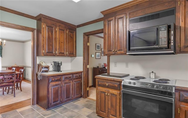 136 Crescent Dr, Franklin, VA 23851 - kitchen featuring electric stove, black microwave, ornamental molding, a chandelier, and light countertops