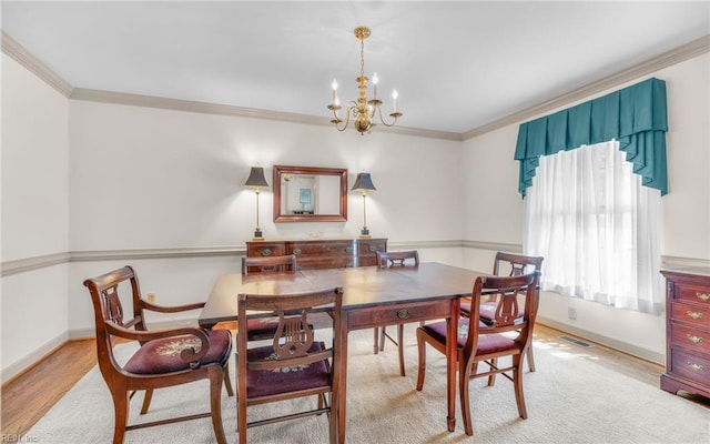 136 Crescent Dr, Franklin, VA 23851 - dining space featuring a chandelier, crown molding, baseboards, and wood finished floors