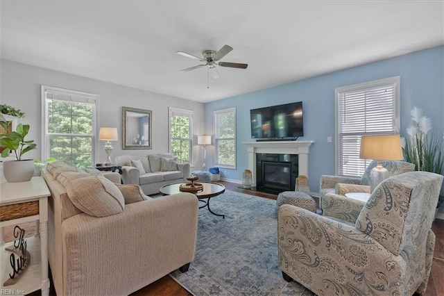 7935 Patriots Landing Pl, Quinton, VA 23141 - living area featuring ceiling fan, dark wood finished floors, a fireplace with flush hearth, and baseboards