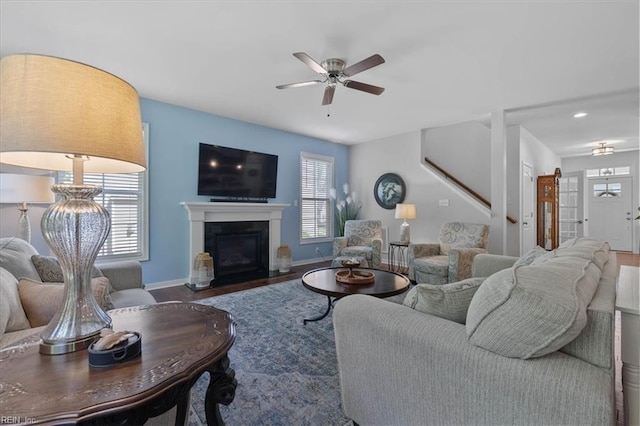 7935 Patriots Landing Pl, Quinton, VA 23141 - living area with a ceiling fan, wood finished floors, baseboards, stairway, and a glass covered fireplace