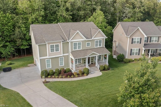 7935 Patriots Landing Pl, Quinton, VA 23141 - view of front of property featuring covered porch, concrete driveway, a front lawn, and a wooded view