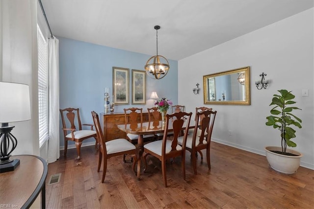 7935 Patriots Landing Pl, Quinton, VA 23141 - dining space featuring wood finished floors, a chandelier, and baseboards