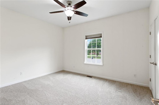 spare room with carpet floors, ceiling fan, and baseboards