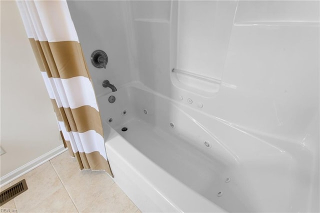 bathroom with tile patterned floors, a combined bath / shower with jetted tub, and baseboards
