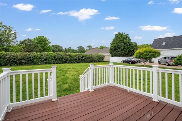 wooden terrace featuring a yard