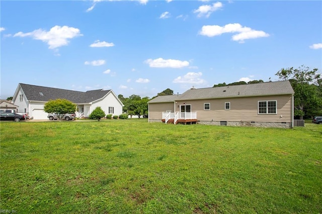 rear view of house featuring central AC, a lawn, a deck, and crawl space