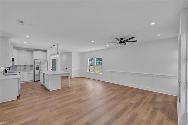 20 Kimberly Ave, Hampton, VA 23663 - kitchen with stainless steel refrigerator with ice dispenser, light countertops, ceiling fan, open floor plan, and white cabinets