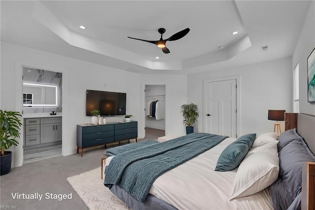 20 Kimberly Ave, Hampton, VA 23663 - bedroom featuring a raised ceiling, light carpet, a spacious closet, ensuite bath, and ceiling fan