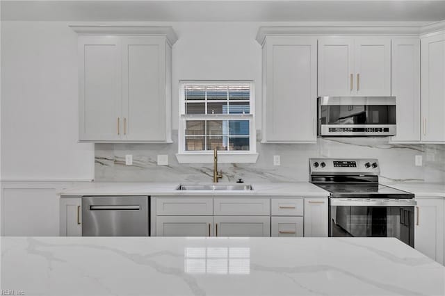 20 Kimberly Ave, Hampton, VA 23663 - kitchen featuring stainless steel appliances, a sink, backsplash, and white cabinets
