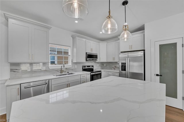 20 Kimberly Ave, Hampton, VA 23663 - kitchen featuring stainless steel appliances, a sink, backsplash, wood finished floors, and decorative light fixtures