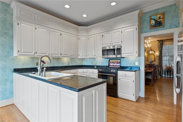 111 Riverside Dr, Suffolk, VA 23435 - kitchen featuring appliances with stainless steel finishes, a sink, light wood finished floors, white cabinetry, and recessed lighting