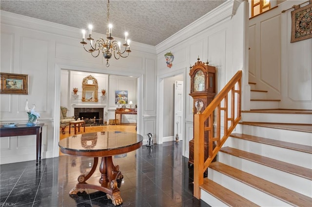 111 Riverside Dr, Suffolk, VA 23435 - entryway with a decorative wall, crown molding, a chandelier, stairway, and a fireplace