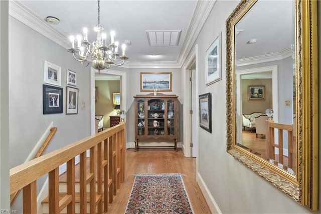 111 Riverside Dr, Suffolk, VA 23435 - corridor with light wood-style flooring, a chandelier, an upstairs landing, ornamental molding, and baseboards